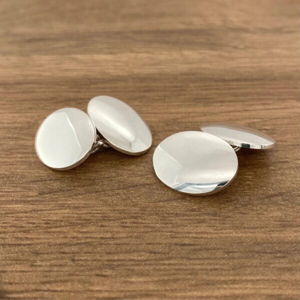 Pair of silver round cufflinks.