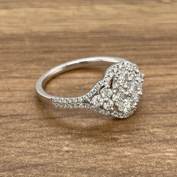 Diamond engagement ring on wooden background.