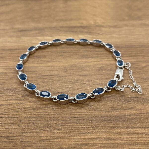 A sterling silver bracelet with blue sapphire stones.