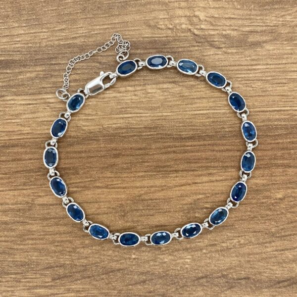 A sterling silver bracelet with blue sapphire stones.