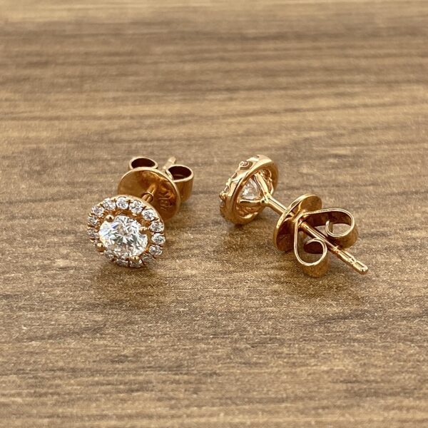 Gold diamond halo stud earrings.