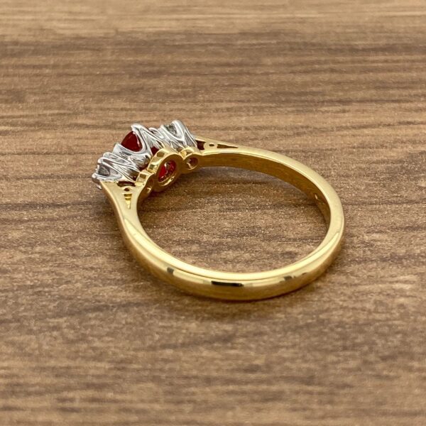 Gold ring with red and white stones.