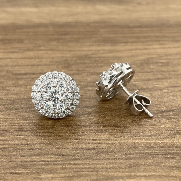Pair of diamond halo stud earrings.
