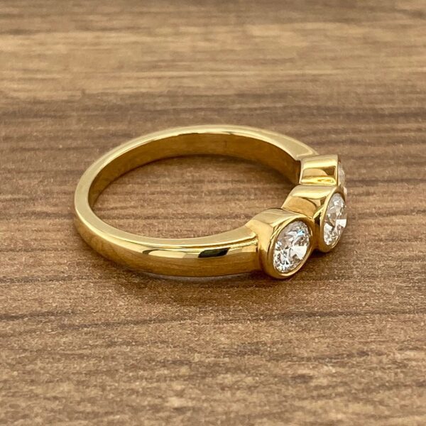 Gold ring with three round diamonds.