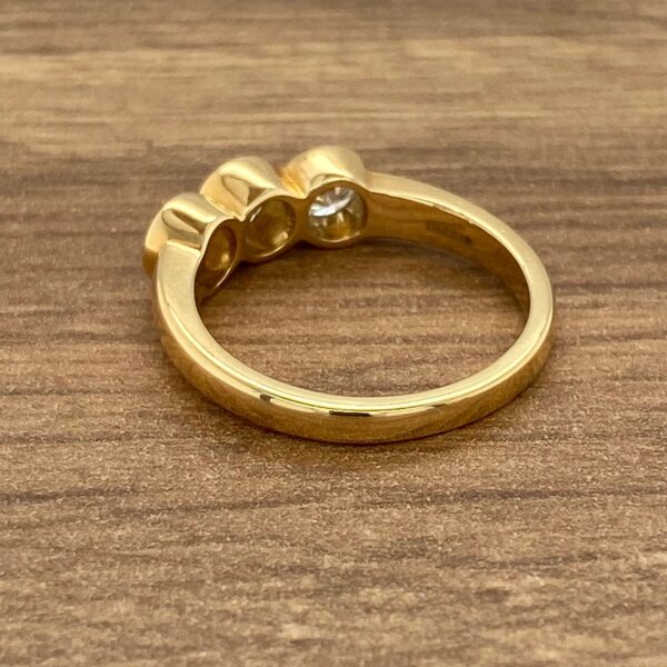 Gold ring with three diamonds.