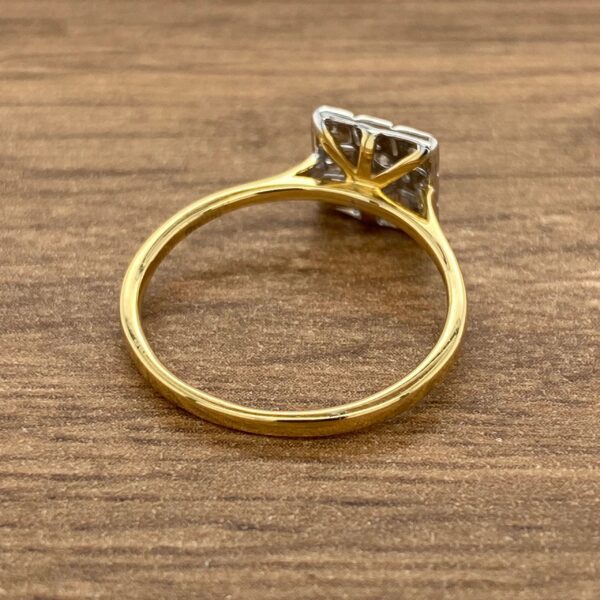 Gold ring with square diamond setting.