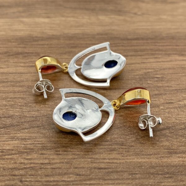Silver and gold earrings with blue stones.