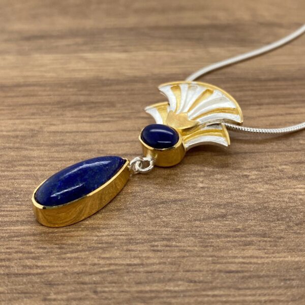 Gold and silver necklace with lapis lazuli stones.