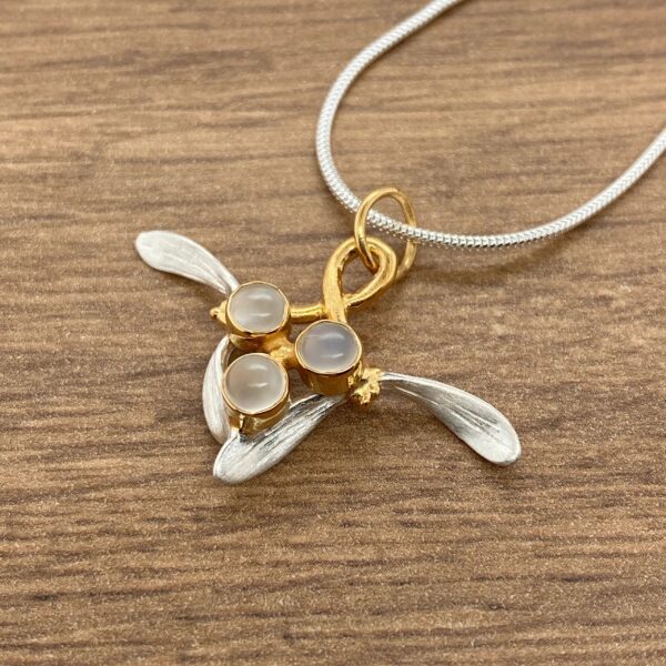 Gold and silver pendant with moonstone gems.