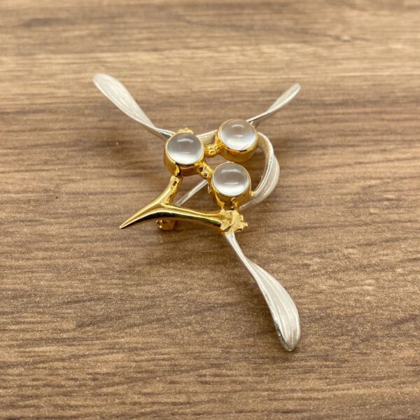 Gold and silver brooch with three stones.