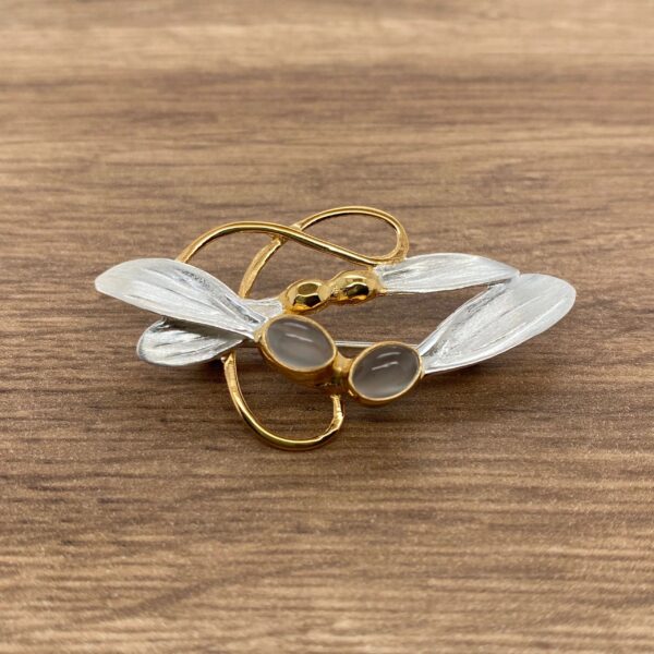 Gold and silver dragonfly brooch with stones.