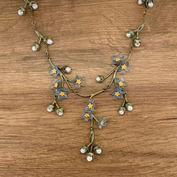 Floral necklace with blue flowers and pearls.