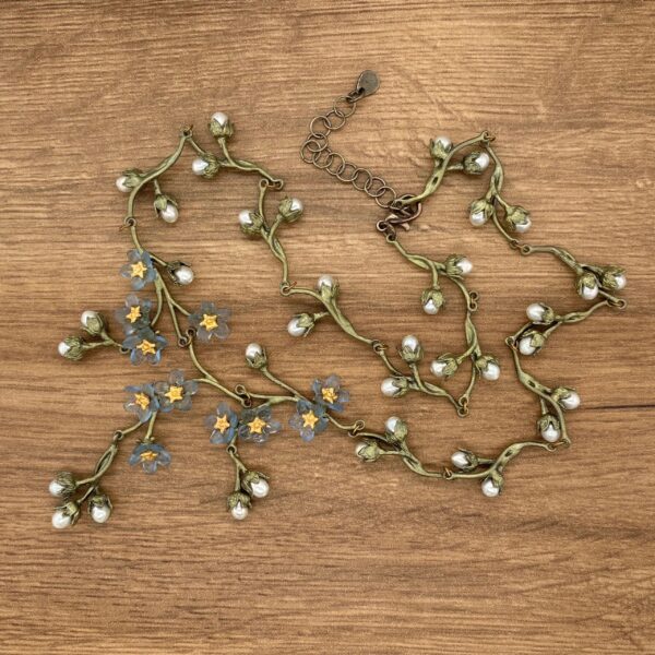 Floral necklace with pearl and blue flowers.