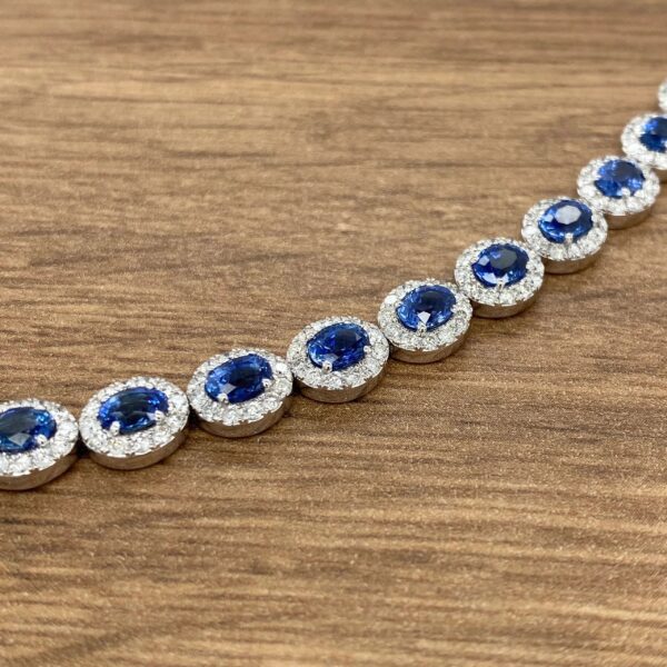 A blue sapphire and diamond bracelet on a wooden table.