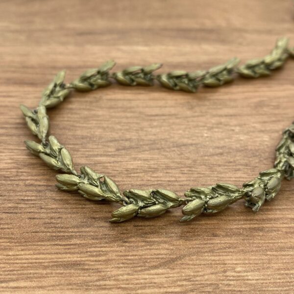 Gold leaf garland on wood background.