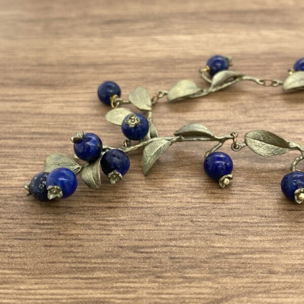 Blue gemstone berry branch necklace.