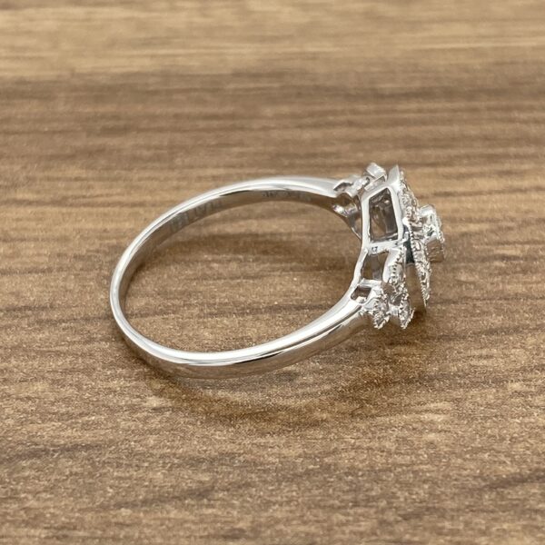 Silver ring with diamond halo setting.