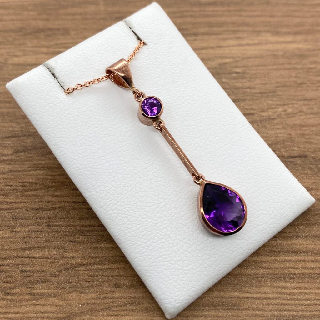 Rose gold necklace with two amethyst stones.