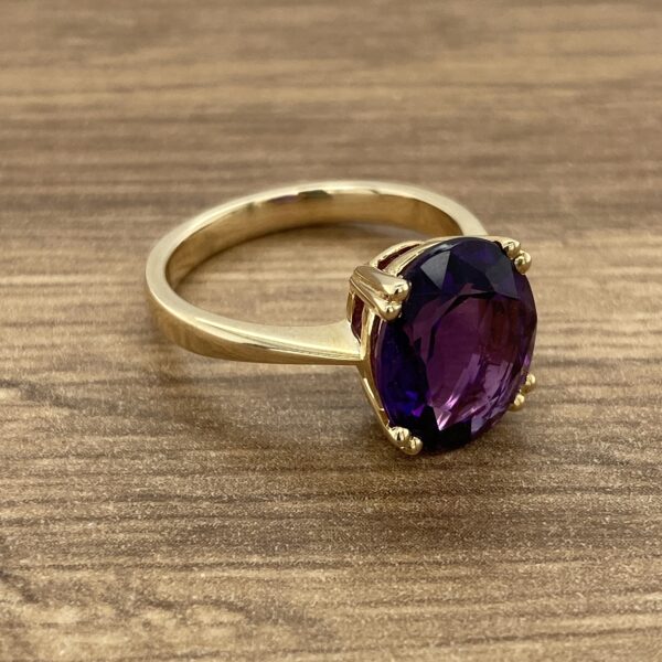 Gold ring with a large amethyst stone.