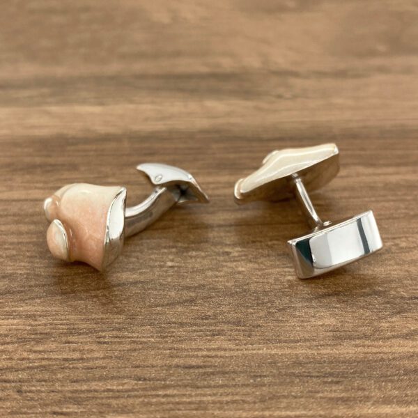 Pair of silver and pink cufflinks.