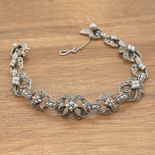 Silver bracelet with pearl and marcasite flowers.