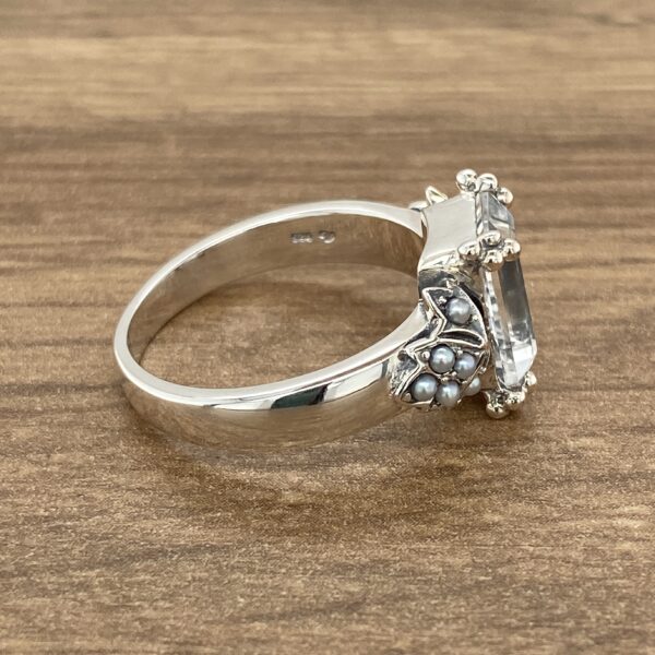 Silver ring with a large clear stone.