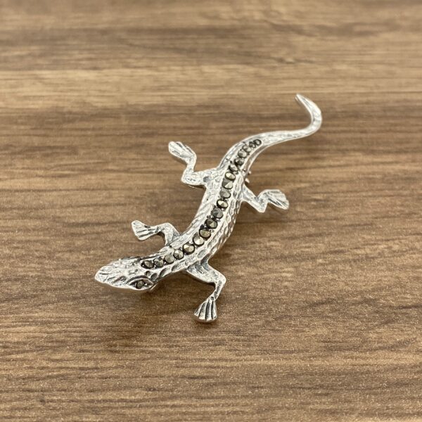 Silver lizard brooch with marcasite stones.
