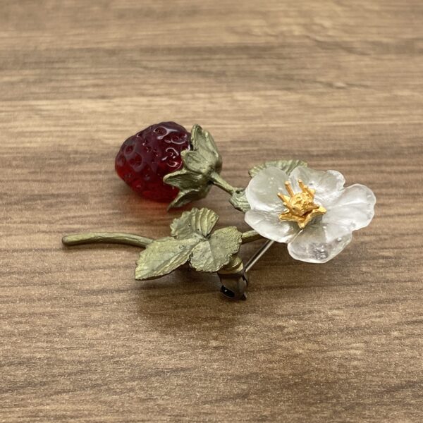Red strawberry and white flower brooch.