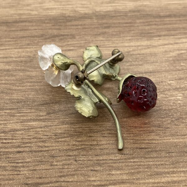 Bronze and glass strawberry brooch.