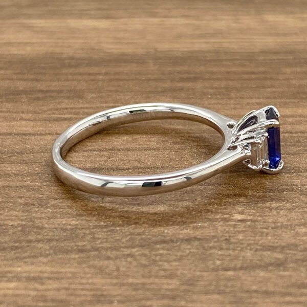 Silver ring with blue sapphire and diamonds.