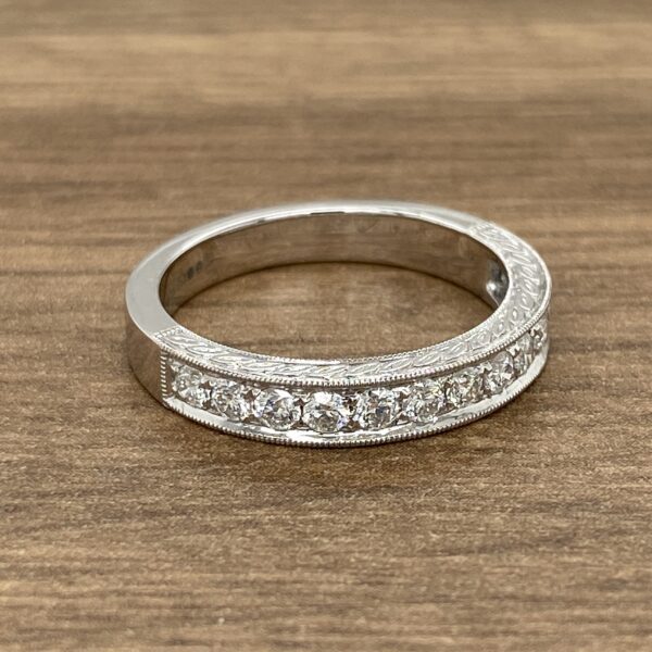 Diamond eternity band on wood background.