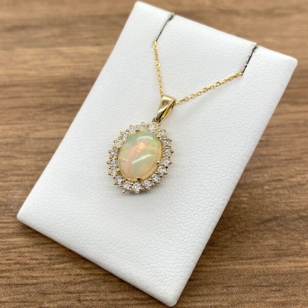 Gold opal pendant with diamond halo.