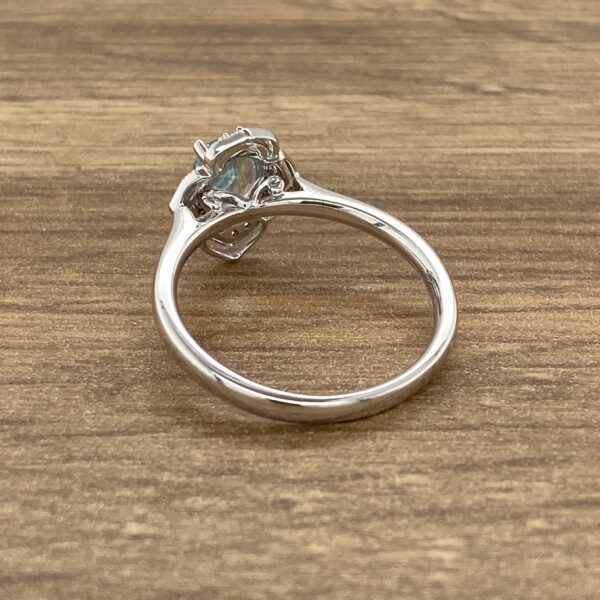 A white gold ring with a blue topaz stone.