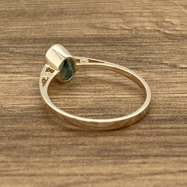 Gold ring with green gemstone.