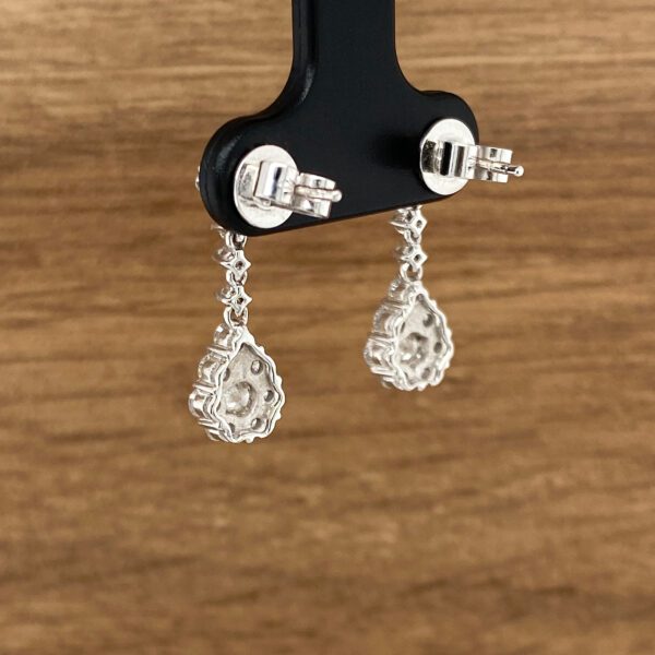 Diamond teardrop earrings on display.