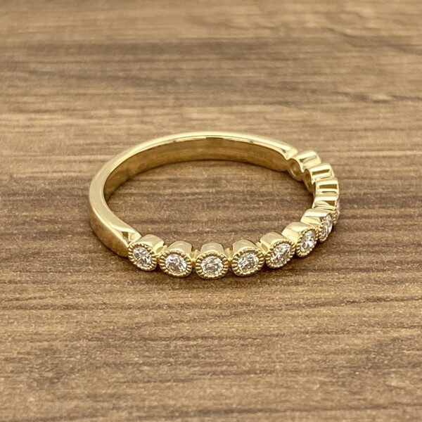 Gold band with bezel set diamonds.