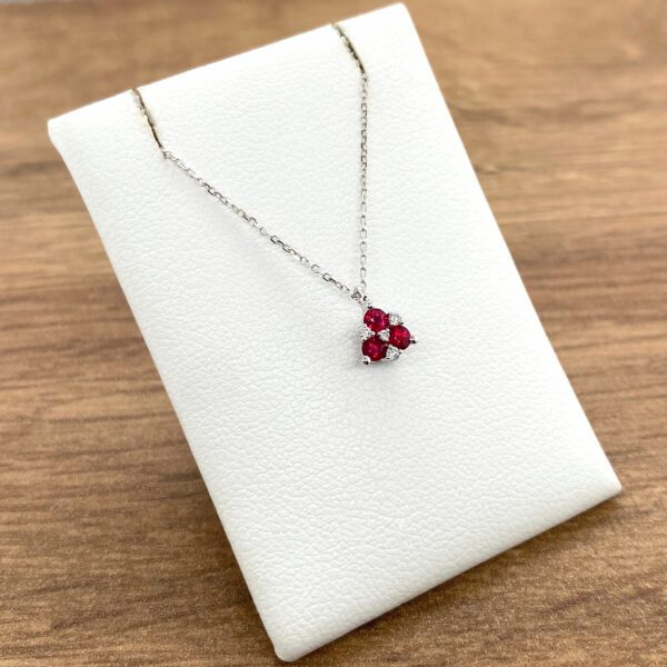 Ruby and diamond pendant necklace on display.