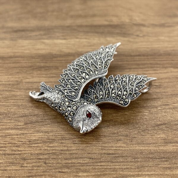 Silver owl brooch with red eye