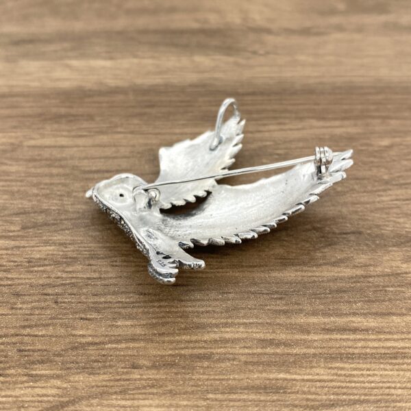 Silver dove brooch with pin on back.
