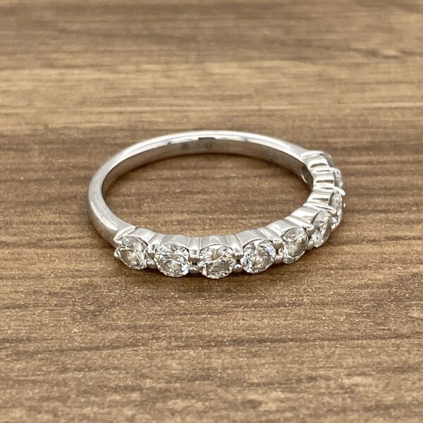 Diamond eternity band on wooden surface.