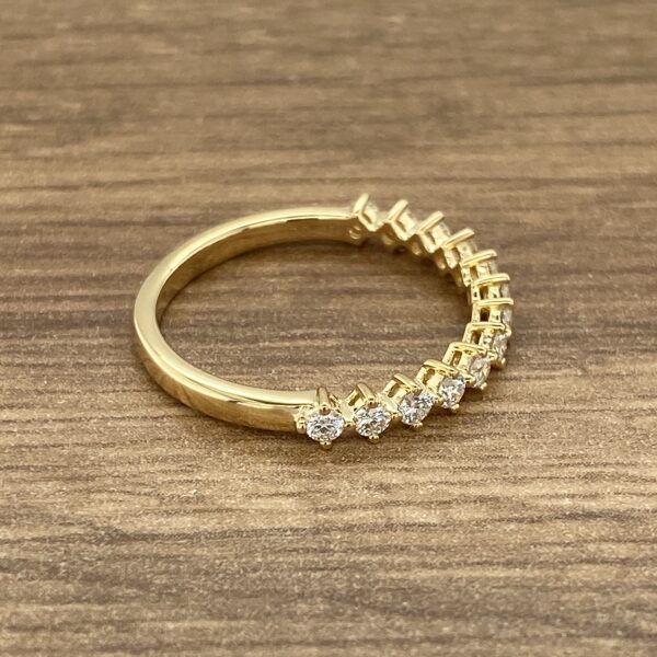 Gold band with a row of diamonds.