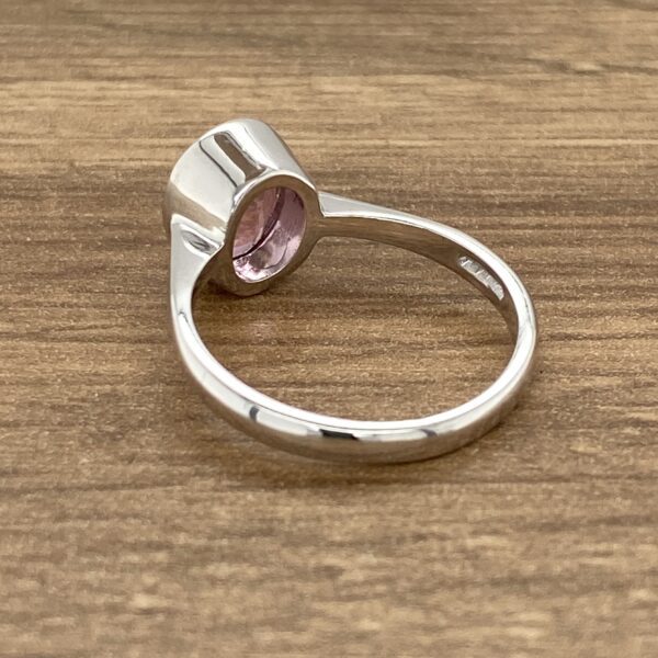 Silver ring with pink gemstone.