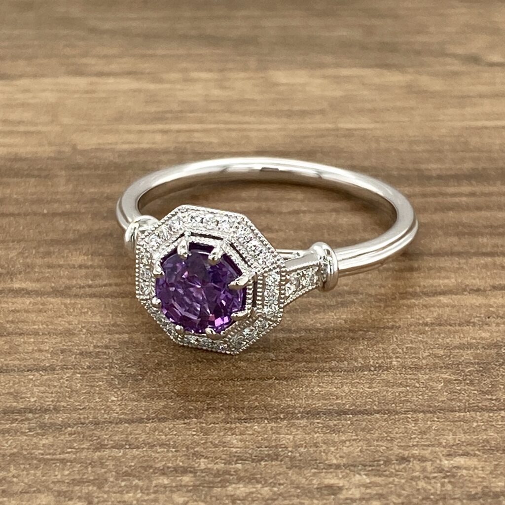 Diamond ring with purple gemstone.