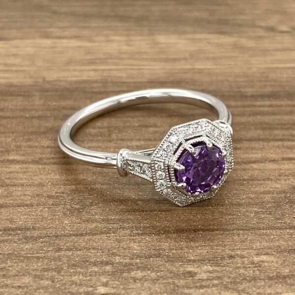 Diamond ring with purple gemstone.