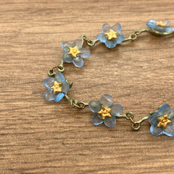 Blue flower bracelet with gold centers.