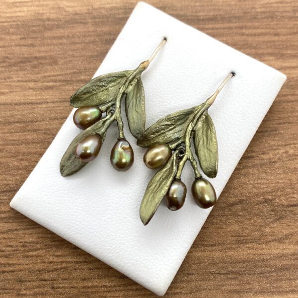 Olive branch earrings with pearl accents.