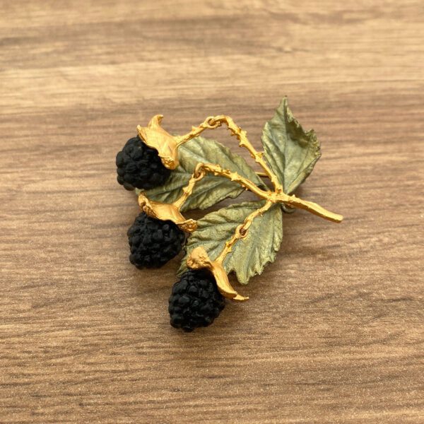 Gold blackberry brooch with leaves.