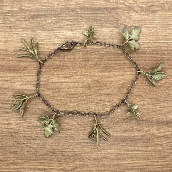 Herb charm bracelet on wooden background.
