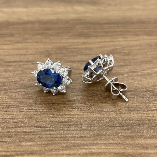Pair of oval sapphire and diamond earrings.