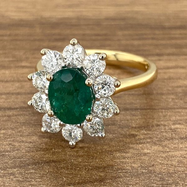 Gold ring with emerald and diamonds.